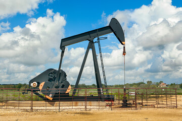 Oil Pump Jack (nodding donkey) in the rural landscape of Texas, USA