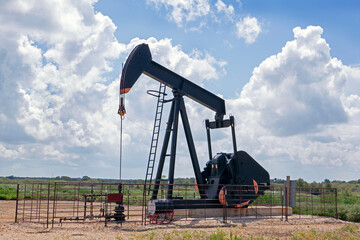 Oil Pump Jack (nodding donkey) in the rural landscape of Texas, USA