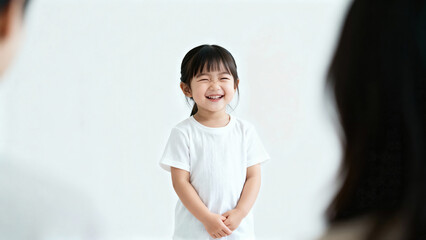 Portrait of a cheerful laughing Asian girl 3-4 years old in a white T-shirt