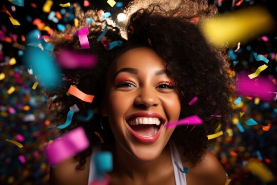 Black woman celebrating laughing confetti smile.