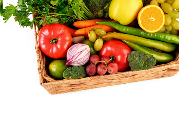 Wicker box with different fresh fruits and vegetables on white background, closeup