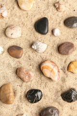 Many pebble stones on sand