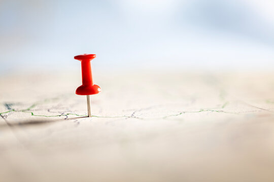 Red thumbtack marking and showing destination location point on map background with copy space