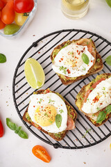 Grid of tasty sandwiches with egg on grey background
