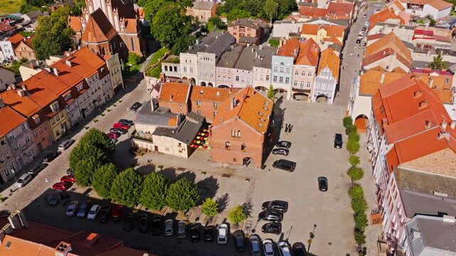 Cinematic orbiting drone view of Gniew old town square with red rooftops