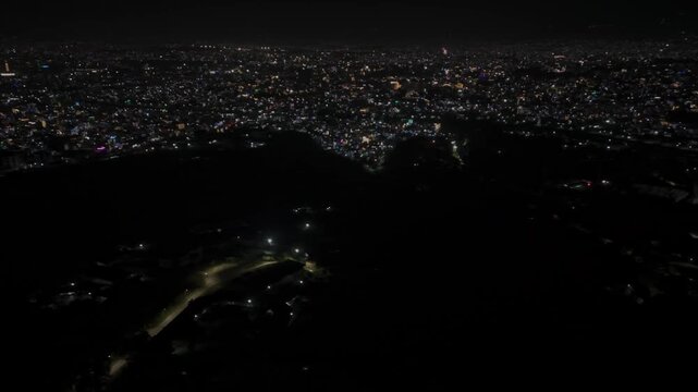 Aerial night footage of Kathmandu city during Diwali (Tihar), featuring the illuminated Dharahara Tower and glowing skyline filled with festive lights, showing Nepal&rsquo;s vibrant cultural celebration.