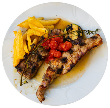 Spanish dish Churasko - barbecue ribs, complemented by baked tomatoes and eggplants. Isolated over white background