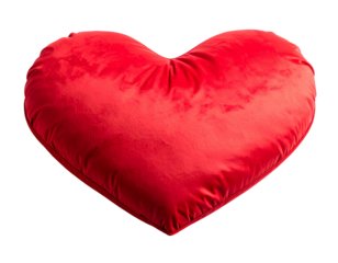 A vibrant, plush, red heart-shaped pillow isolated on a solid black background