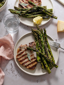 Dinner with grilled pork steak and asparagus