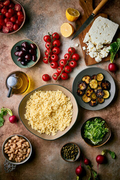 Mediterranean Salad Ingredients on a clay coloured table