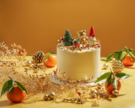 Modern Christmas Cake with Champagne on Yellow Background, golden decor on a modern yellow background