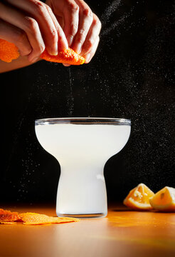 Spraying Citrus Peel Over a Cocktail Glass