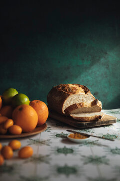Bread, Citrus fruits and Jam on a rustic table