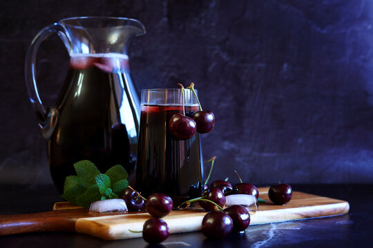 Pure Black Cherry Juice on Dark Background with Negative Copy Space.