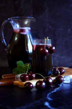 Pure Black Cherry Juice on Dark Background.
