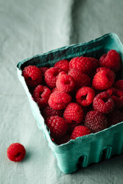 organic raspberries from the market on turqoise cloth