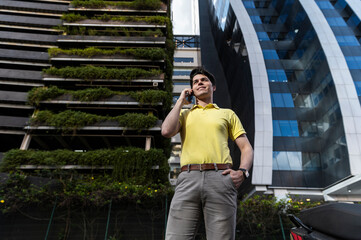 Corporate professional making phone call beside green office building