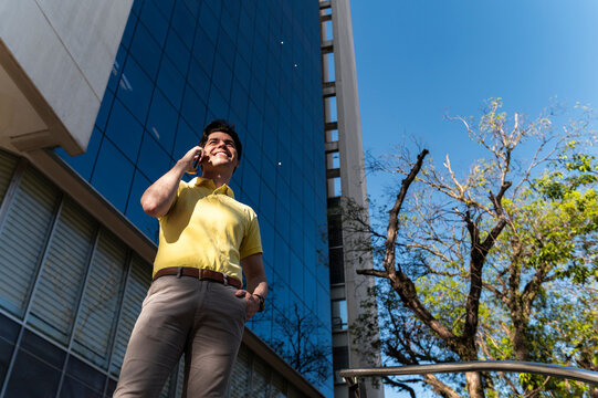Entrepreneur on phone call outside modern glass building
