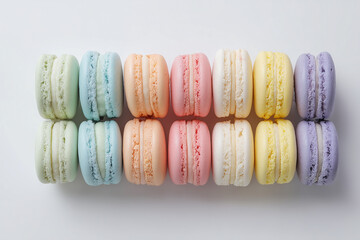 Top view of colorful macarons on white background. Multicolour macaroon sweet dessert French cuisine style for coffee break
