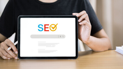 Person Holding Tablet Showing SEO Search Engine Optimization for Digital Marketing