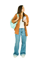 Cute woman holding phone and looking up at copy space in a studio