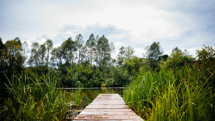An old fishing bridge on the river in the summer. background image