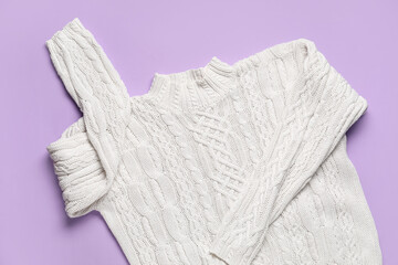 Knitted female sweater on lilac background