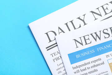 Different newspapers on blue background