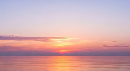 Obraz premium Vibrant sunset over calm water, painting the horizon with warm hues and reflections.
