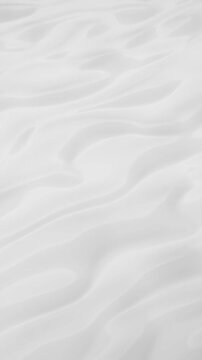 White milk-like surface waves flow with reflections. Vertical abstract animation of white surface with waves flows
