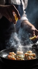 A close-up of a chef's hands squeezing fresh lemon onto sizzling shrimp.
