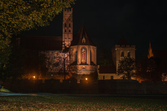 Malbork Castle at night with illuminated red brick walls in Poland - Powered by Adobe
