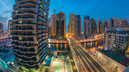 Fototapeta premium An Aerial view of Dubai Marina towers in Dubai day to night timelapse