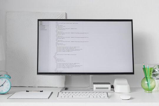 Programmer's desk with computer monitor in light office