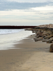 Morning view along Tharangambadi beach in Tamil Nadu, with calm waters of the Bay of Bengal meeting...