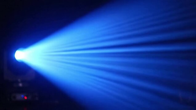 Powerful blue laser light beam projecting across dark foggy space, futuristic high-energy illumination and sharp focus.
