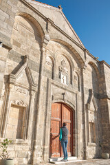 Tourist entering Timios Prodromos church in Vouni village, Cyprus