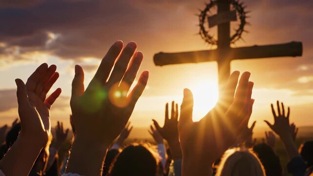 Religious Gathering at Sunset - This video shows a group of people with their hands raised in worship, facing a wooden cross adorned with a crown of thorns against the backdrop of a golden sunset.