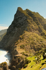 Dramatic hillside surrounded by meadows and distant sea