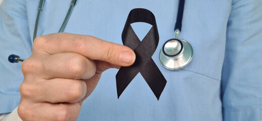 Doctor Holding Black Ribbon in Support of Mourning