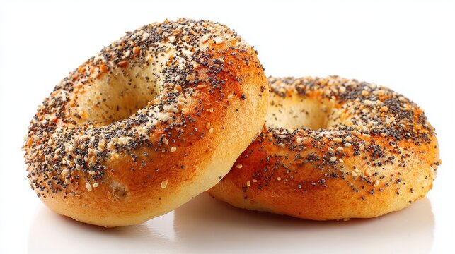 Freshly baked poppy seed bagels on a white background