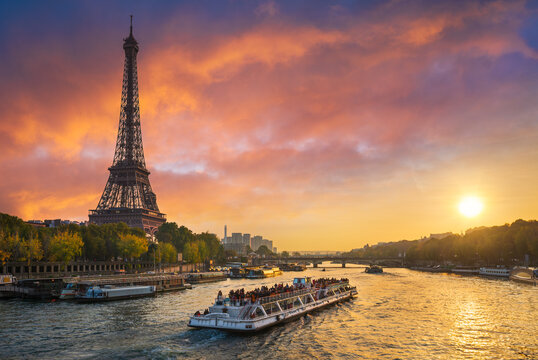 Sunset at the Eiffel tower, Paris, France with a tourist boat