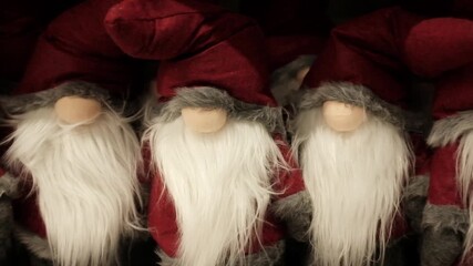 Santa Claus soft cozy cute traditional Christmas plush toys. Winter holidays decoration and toys for kids. Xmas spirit gifts, holidays items, store shelves merchandise. Getting ready for Christmas.