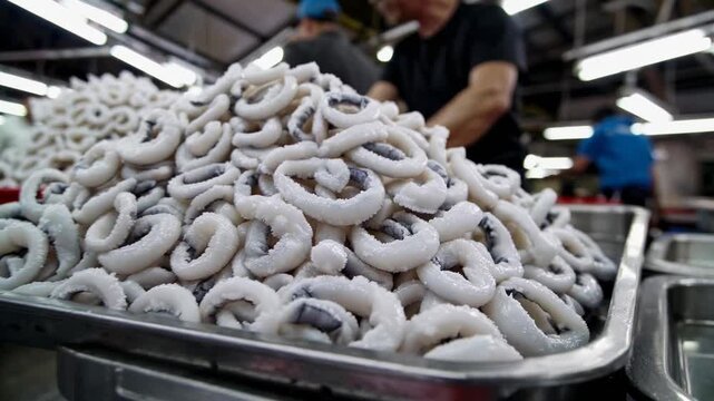 Salted fish preparation at a bustling seafood market in the early morning light