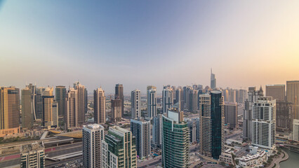 Obraz premium Aerial top view of Dubai Marina morning timelapse. Modern towers and traffic on the road