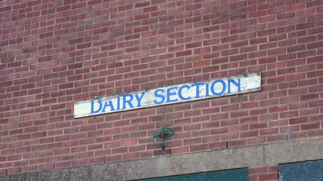 Dairy Section sign on old brick building at British countryside farmers market
