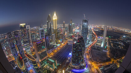 Skyline of the buildings of Sheikh Zayed Road and DIFC aerial day to night timelapse in Dubai, UAE.