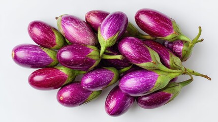 Overhead shot of new Thai eggplants stacked on a white background
