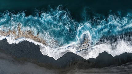 Overhead shot of waves crashing on Reynisfjara s black sands in Iceland s Vík highlighting dynamic natural patterns of the Atlantic