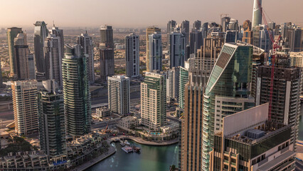 Obraz premium Dubai Marina skyscrapers and jumeirah lake towers sunrise view from the top aerial timelapse in the United Arab Emirates.